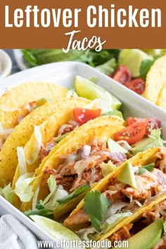 a white plate topped with tacos covered in meat and lettuce next to tortilla chips