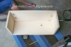 a wooden box sitting on top of a blue rug