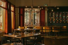 a restaurant with wooden tables and yellow chairs