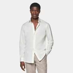 This off-white shirt is tailored to a casual tailored fit and features a classic collar, single cuff, and a French placket. Elegant Formal Linen Tops, White Collared Business Shirt, Timeless Summer Shirt With Spread Collar, White Shirt With Concealed Placket For Summer, Timeless Button-up Shirt For Summer, Timeless Button-up Summer Shirt, Modern White Dress Shirt For Semi-formal Occasions, Formal Shirt With Lapel Collar And Relaxed Fit, Classic Slim Fit Summer Dress Shirt