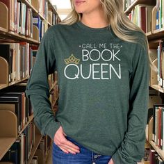 Book Queen Long Sleeve Unisex T-shirt - Perfect for Readers and Librarians! Embrace your royal book-loving status with our *Book Queen* long sleeve T-shirt, designed for readers and librarians alike. This unisex tee is soft, comfortable, and perfect for those cooler days spent diving into your favorite reads or managing your library kingdom. Whether you're shelving books or curled up with a classic, this shirt lets everyone know who's in charge of the literary world. Features: - Unisex fit for a Bookish Crew Neck Top With Text Print, Bookish Long Sleeve T-shirt With Letter Print, Bookish Long Sleeve Cotton Tops, Literary Long Sleeve Tops With Letter Print, Literary Long Sleeve Cotton Tops, Loving Status, Book Clothes, Look Plus, Librarian