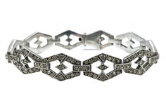 This is a beautiful antique Art Deco era (1920 - 1940) 935-grade silver geometric style/design link bracelet with clear paste stones. The bracelet weighs 28.64 grams in total. The bracelet comes with a presentation box displayed in the images (not original). History: The Art Deco (French - Arts Décoratifs) received its name after the famous exposition in Paris Exposition of Modern Decorative and Industrial Arts. However, the movement and its significant style started much earlier, in Paris, arou Art Deco White Gold Diamond Bracelet, Art Deco Diamond Bracelet With Accents, Vintage Silver Diamond Bracelet With Single Cut Diamonds, Art Deco Silver Diamond Bracelet, Art Deco Silver Diamond Bracelets, Art Deco Diamond Bracelet In Silver, Art Deco Silver Bracelet With Single Cut Diamonds, Art Deco Silver Bracelets With Single Cut Diamonds, Art Deco Diamond Bracelet For Anniversary