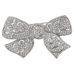 This elegant brooch in a bow tie design, crafted with all brilliant diamonds with a total carat weight of 4.16. Sophia D by Joseph Dardashti LTD has been known worldwide for 35 years and are inspired by classic Art Deco design that merges with modern manufacturing techniques. Elegant Diamond White Brooches For Formal Occasions, Formal Diamond White Brilliant Cut Brooch, Elegant Brilliant Cut Brooches For Anniversary, Elegant Brilliant Cut Brooches As Gifts, Elegant Anniversary Brooch With Bow, Elegant Diamond Accents Brooches For Formal Occasions, Elegant Formal Brooches With Single Cut Diamonds, Formal Single Cut Diamond Brooch, Elegant Brooches With Diamond Accents For Formal Occasions