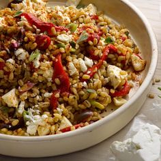 a white bowl filled with food on top of a table