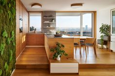 an open kitchen and dining area with moss growing on the wall