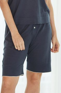 Inspired by vintage French bloomers, these cozy sleep shorts are updated with our signature modern-minimalist style. Super soft against the skin, these pj bottoms feature contrast tipping at the hem for a refined finish. They’re the loungewear-luxe shorts you’ve been waiting to dream in. Lightweight organic cotton blend knit Drawstring waistband with one button closure on placket Contrast stripe at hem in ivory Model is a size 4 and wears a size small Inseam length is 9" for size small Machine w Summer Loungewear Bottoms With Contrast Trim, Contrast Trim Loungewear Bottoms Short Length, Camel Shorts, Cozy Sleep, Pj Bottoms, Favorite Daughter, Sleep Shorts, Maternity Shops, Designer Clothes For Men