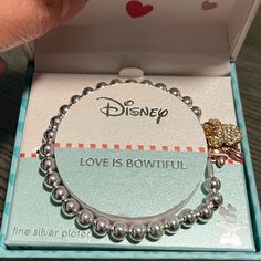 Disney Bracelet With Charms Bow, Mini & Love New In Box, Silver Beads, Stretchy Themed Bracelets As Valentine's Day Gift, Themed Bracelets For Valentine's Day Gift, Themed Valentine's Day Gift Bracelets, Disney Silver Bracelet For A Gift, Silver Disney Bracelet As Gift, Disney Silver Bracelet Gift, Disney Style Silver Jewelry With Charms, Silver Disney Bracelet For Gift, Pandora Charm Bracelet Disney