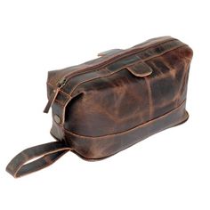 Upgrade your grooming game with the Jaald Leather Toiletry Bag. Made from 100% genuine leather, this durable, handcrafted bag combines rugged style with functionality. The design features a spacious main compartment, two small pockets, and a water-resistant lining to keep your essentials organized and dry. With high-quality YKK metal zippers and a leather handle for easy carrying, its perfect for travel, the gym, or home use. Ideal as a gift for men and women, its a stylish and practical choice Brown Leather Pouch With Large Capacity, Large Capacity Leather Travel Cosmetic Bag, Brown Rectangular Cosmetic Bag For Business, Rectangular Brown Cosmetic Bag For Business, Rectangular Brown Business Cosmetic Bag, Brown Pouch For Everyday Use, Business Portable Leather Pouch, Large Capacity Brown Leather Wallet, Brown Large Capacity Leather Wallet