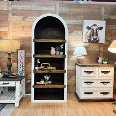 a room with wooden walls and shelves filled with items on top of eachother