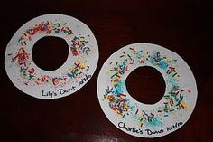 two paper donuts with sprinkles on them