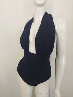 "FREE SHIPPING TO USA FOR ALL ORDERS OVER 35$! Choose right size by following our size chart below, thank you! We use FEDEX PRIORITY shipping service to the United States to guarantee the fastest delivery in 3-4 days. Flattering one piece swimsuit in dark blue fabric with open back and high cut. It has a deep neckline secured at the back of the neck with a halter tie. Stretchy and body fitting material. COLOR: DARK BLUE MEASUREMENTS: X-Small - Bust - 32\" - 34\" (82-86 CM) - Hips - 35\" - 36\" ( Fitted One-piece Bodysuit For Sunbathing, Fitted One-piece Lined Swimwear, Single Color Backless One Piece For Beachwear, Fitted Bodysuit For Beach, Fitted Solid Color Bodysuit For Beach Party, Backless Fitted Bodysuit For Beach Party, Fitted Backless Bodysuit For Beach Party, Solid Color Backless One-piece Beachwear, Fitted Solid Bodysuit For Beach Party