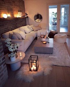 a living room filled with furniture and candles