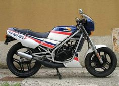 a white and blue motorcycle parked next to a building