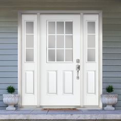 a white front door with two planters on either side