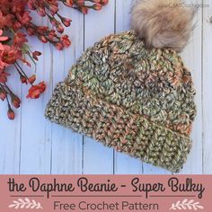 a crocheted beanie with a pom - pom on top and the text, the dapple beanie super bulky free crochet pattern