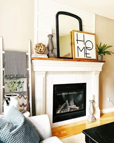 a living room filled with furniture and a fire place in front of a tv mounted on a wall