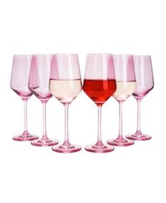 four wine glasses are lined up in a row with one red and the other white