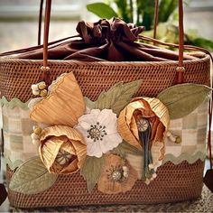 a woven basket with flowers painted on it