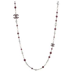 Pre-owned Chanel graduated faux pearl necklace (or belt) crafted in dark silver tone (circa 2014). The necklace features graduated 8mm to 12mm faux white pearls, separated with 8mm to 12mm maroon beads. Two CC logos separate the beads. The necklace can be worn as a long 47-inch chain or wrapped as a double-strand necklace. Also great for wear as a belt. The necklace features a dark silver metal tone with rich maroon-hued beads and lacquer detail to the CC logos (double-sided). The necklace is in Double Strand Necklace, Faux Pearl Necklace, Travel Pouch, White Pearl, Bead Necklace, Pearl White, Faux Pearl, Metallica, Metallic Silver