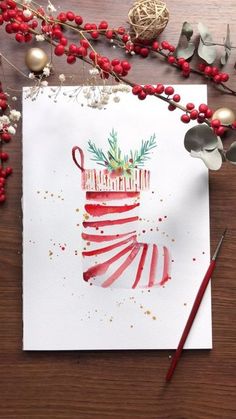 a card with a christmas stocking on it next to red berries and silverware