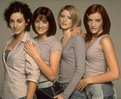 four young women are posing for the camera