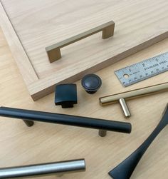 various tools are laid out on a table with a ruler, pencils, and other items