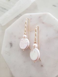 These earrings are unique yet perfectly on trend and timeless. Perfect for dressing up a casual look or for a bride on your wedding day! Handmade from top quality materials. Genuine lustrous freshwater coin pearls are threaded with 14k gold filled beads on 14k gold filled wire. Gold fill does not wear off like gold plated. Water safe! Hypoallergenic, lead and nickel free. Comfortable and lightweight! Come packaged in a gift box. **What is 14k Gold-fill?** Gold fill does not tarnish or wear off a Feminine Pearl White Drop Bridal Earrings, 14k Gold Filled Pearl Drop Earrings For Anniversary, Pearl White Pearl Drop Linear Earrings, Feminine Dangle Pearl Earrings, Feminine Gold Pearl Earrings For Wedding, Pearl White Linear Pearl Drop Earrings, Elegant White 14k Gold Filled Bridal Earrings, Pearl White Linear Earrings With Pearl Charm For Wedding, Pearl White Earrings With Pearl Charm In 14k Gold