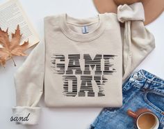 Game Day Shirt, Touchdown Football Shirt, Game Day Mom Shirt, Game Day Sweatshirt, Football Sweatshirt, Sport Mom Shirt HOW TO ORDER: Check all photos. Select your size. Select your color. Enter design or text color in the personalization box (see images for options). Select the quantity. Add to cart. Complete checkout. SWEATSHIRT DETAILS: 50% Cotton, 50% Polyester 1x1 ribbed collar, cuffs, and waistband with spandex Set-in sleeves UNISEX SIZING Brands: Gildan, Jerzees, Hanes, Laviva (brand not Game Day Sweatshirt, Sports Mom Shirts, Sport Mom, Sweatshirt Details, Football Sweatshirt, School Games, Game Day Shirts, Sports Mom, Football Shirt