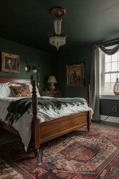 a bed sitting in a bedroom on top of a rug next to a window with a chandelier