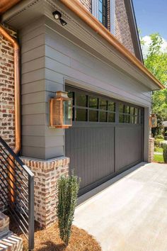 a garage door is open on the side of a house