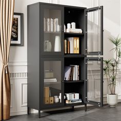 a book shelf with many books on it in a room next to a potted plant