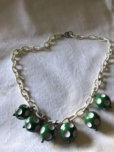 "Very cute fun costume jewelry from the 1940's-50's. Plastic chain link could be celluloid or maybe Bakelite. Little green and white dotted balls are possible the same. Playful costume jewelry from the 1940's. Measurements are; From end to end 17\" Feel free to convo me with any further questions. Thank you for your interest." Adjustable Retro Jewelry, Retro Lucite Jewelry As Gift, Retro Lucite Jewelry Gift, Retro Lucite Jewelry Perfect As A Gift, Handmade Retro Green Jewelry, Handmade Retro Bakelite Jewelry, Green Vintage Necklaces With Vintage Charm, Vintage Green Necklaces With Vintage Charm, Vintage Green Necklace With Vintage Charm