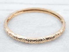 "This vintage bangle bracelet is full of romance and elegance! A simple patterned design is accented by a wonderful patina that adds wonderful depth to the polished 18-karat gold. The hinged design allows for easy on-and-off functionality. Metal: 18K Yellow Gold Width: 6.0 mm Inside Circumference: 7 Inches Marks: \"GM P\" Stamped on the clasp To view a video of this piece check out the link below: https://vimeo.com/810180149 SKU #: A21533 Each piece has been identified and graded by a Graduate Gemologist who has been certified by the Gemological Institute of America (GIA). We have six brick-and-mortar storefronts in Maine, Massachusetts, and New Hampshire and have been in business for over 25 years! Please visit our Shop's About Page or our website for more information about our jewelry. F Classic Gold Bracelet With Intricate Design, Classic Yellow Gold Band Bracelet, Classic Bracelets With Decorative Band For Formal Occasions, Classic Gold Bangle Bracelet With Intricate Design, Elegant Bracelet With Decorative Band For Anniversary, Elegant 14k Gold Bracelets With Decorative Band, Classic Gold Bangle With Intricate Design, Classic 14k Gold Bracelets With Intricate Design, Classic Gold Bracelet With Intricate Design For Anniversary