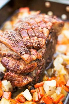 a close up of meat and vegetables in a skillet