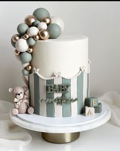 a baby shower cake with balloons on top