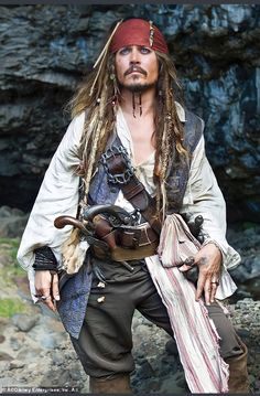 a man dressed as captain jack sparrow with dreadlocks and a pirate's hat