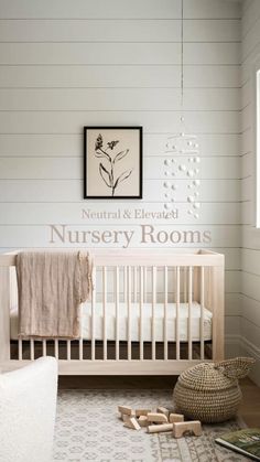 a baby's room with white walls and wood floors