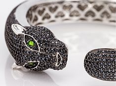 14.19ctw round black spinel with .20ctw round Russian chrome diopside rhodium over sterling silver panther bangle bracelet. Measures approximately 0.69"W x 0.50"H. Finished under gallery. Black rhodium. Panther Jewelry, Black Gems, Spinel Gemstone, Broken Chain, Black Spinel, Pearl Strands, Black Rhodium, Bangle Bracelet, Post Earrings