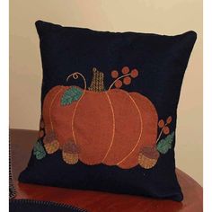 a decorative pillow with a pumpkin on it