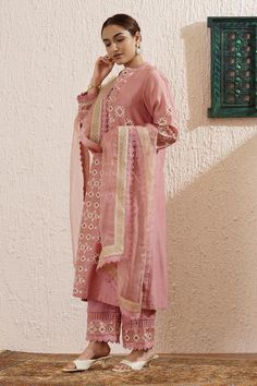 Pink long sleeves block printed straight kurta in chanderi base with side slits and lace detailing on the sleeves. Paired with lace and block print detailing pant and an organza dupatta with gold and same coloured lace.
Components: 3
Pattern: Print
Type Of Work: Floral Block
Neckline: Notched V
Sleeve Type: Long
Fabric: Chanderi
Color: Pink
Other Details: 
Attached inner lining
Model Height: 5ft 4inches, wearing size S
Note: The hair accessory worn by the model is not for sale
Occasion: Puja, Me Block Print Mulmul Sharara With Straight Kurta, Chanderi Sharara With Block Print Straight Kurta, Eid Mulmul Sharara With Block Print, Eid Block Print Mulmul Sharara, Wedding Palazzo Set With Block Print Straight Kurta, Festive Sharara With Block Print And Straight Kurta, Festive Block Print Sharara With Straight Kurta, Navratri Straight Kurta Sharara With Block Print, Traditional Palazzo Set With Block Print