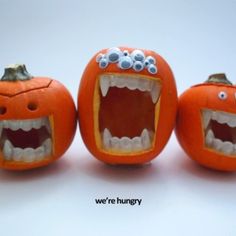 three carved pumpkins with mouths and teeth