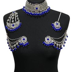 Handcrafted royal blue silver kundan Indian wedding / bridal jewellery set. Set includes- Earrings with multilayer pearl sahara  Choker necklace Jhumar Tikka  Our choker is adjustable with a dori at the back giving you a comfortable fit. It comes with elegant kundan earrings with pearl detail, tikka and jhumar with hooks.  The subtle glimmer of the kundan with elegant pearl detail makes this jewelry set a truly head turning piece, a must have for every jewellery box.  Our ethnic jewellery set ha Silver Jewelry Sets For Eid, Silver Hand Set Jewelry For Eid, Heavy Silver Jewelry For Eid, Silver Chandbali Lehenga With Stone Work, Silver Bollywood Lehenga With Stone Work, Bollywood Style Silver Lehenga With Stone Work, Silver Tilla Jewelry Sets For Eid, Silver Hand-set Bridal Necklace For Eid, Silver Hand Set Bridal Necklace For Eid