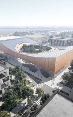 an aerial view of a large building in the middle of a city with lots of trees and buildings around it