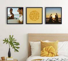 three framed photos hang on the wall above a bed