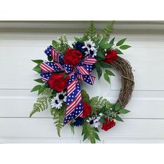 a patriotic wreath with red, white and blue flowers