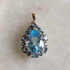 This stunning Pendant is set in 14k Solid Yellow Gold with Natural Sky Blue Topaz with utmost precision. It is a unique gemstone Pendant for nearly every occasion and is completely hassle-free jewelry. ITEM DETAILS: * GEM: Sky Blue Topaz * GEM SIZE: 10x14mm * GEM SHAPE: Oval * GEM: London Blue Topaz * GEM SIZE: 3x4mm 7pcs * GEM SHAPE: Oval * GEM: London Blue Topaz * GEM SIZE: 2.5mm 7pcs * GEM SHAPE: Round *TOTAL GEM  WEIGHT: 8.10 carats * Gold Purity: 14KT (58.33% approx.) * Gold Weight: 1.81 gram * Total Weight of the Pendant: 3.43 gram The Gold purity is guaranteed and it comes with authentic 14KT gold hallmark. Since my items are handmade, they are absolutely nickel and lead free. CUSTOMIZATION: * Gemstone customization is available and it can be substituted with a gem of your choice. K Blue Gemstones With Accents Fine Jewelry, Blue Topaz Pear-shaped Jewelry, Blue Pear-shaped Topaz Jewelry, Fine Jewelry Blue Topaz Gemstones, Pear-shaped Blue Topaz Yellow Gold Jewelry, Elegant Blue Topaz Gemstones, Blue Multi-stone Gemstone Pendant, Fine Jewelry Blue Topaz Pear-shaped, Fine Jewelry Blue Topaz In Pear-shaped