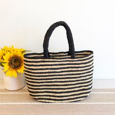 IN STOCK FAST SHIPPING FROM LOS ANGELES Take your beach style to the next level with our Elena Handbags Raffia Summer Beach Striped Straw Tote Bag! This bag features a classic and stylish striped design, perfect for any summer outing. Made with durable raffia material, it's the ideal choice for all your beach essentials. (No more sandy bags!) Natural Raffia Straw Handmade Unlined Size: 10"H x 16"W Handle drop length: 7" Designer Style ID: 8695 Beach Bag With Braided Handles, Vacation Beach Bag With Top Handle, Vacation Beach Bag With Top Handle And Rolled Handles, Casual Top Handle Bags For Beach Season, Woven Top Handle Beach Bag For Travel, Top Handle Bag In Natural Color For Beach Season, Beach Bag With Rolled Top Handles, Beach Season Bags With Braided Handles And Top Handle, Daily Use Summer Beach Bag With Top Handle