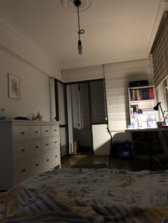 a bedroom with a bed, dresser and bookshelf in the corner next to it