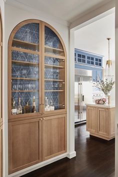 a kitchen with wooden cabinets and blue tile backsplashing on the back wall