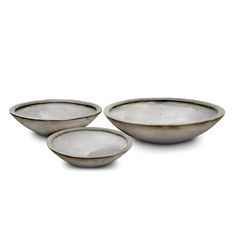 three white bowls sitting next to each other